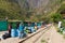 People and baggages on railway track to Machu Picchu, Peru