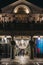 People on the balcony of Punch & Judy pub above the entrance to Covent Garden Market, London, UK