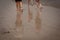 People barefeet walking on a shoreline