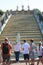 People at the base of Cascade Golden Mountain on a bright sunny day. Lower Park, Peterhof