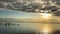 People bathe in the Dead Sea in Israel. Beautiful sunrise clouds