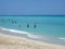 People bathe in shallow waters at Miami Beach