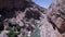 People bathe in a stream flowing in a mountain gorge