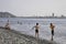 PEOPLE ON THE BEACH OF BATUMI IN THE BACKGROUND BATUMI HARBOUR