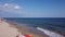 People Beach. Beach people sunbathing, sun loungers, relaxation near the sea. Sea waves and sand. People swim in Black sea
