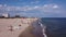 People Beach. Beach people sunbathing, sun loungers, relaxation near the sea. Sea waves wash the golden sand