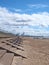 People on the beach at blundell sands in crosby near southport merseyside with seafront railings and Liverpool docks visible in