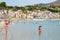 People on beach near waterfront of Giardini Naxos