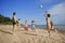 People on the beach playing volleyball