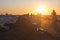 People on bikes ride along the in the sea at sunset