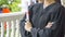 People with black graduation gowns hold diploma.