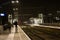 People blurred by motion at station Arnhem south at night