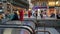 People boarding an escalator entrance to a railway subway on a street in Vienna, Austria as tourists pass by