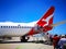 People boarding a Qantas domestic airline Aircraft Type: Boeing 737 on the runway.