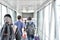 People boarding to aircraft in airport using boarding bridge