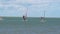 people on boards for Windsurfing on the high seas.