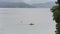 People in a boat floating on the lake in a foggy morning in front of beautiful mountains in Bangladesh. Action