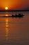 People on boat at sunset