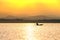 People in boat with sunshine at lake