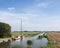 People and boats in canal of tipical frisian landscape in the north of the netherlands