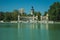 People with boats on pool in front of monument in a park of Madrid