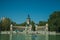 People with boats on pool in front of monument in a park of Madrid