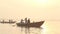 People in boats sailing down the river Ganges at sunset.