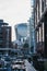 People and boats in St. Katharine Docks, London, Walkie Talkie building on the background