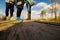 People in boots walk along a wooden path in a swamp in Yelnya, Belarus