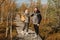 People in boots walk along a wooden path in a swamp in Yelnya, Belarus