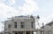 People are building a precast house in construction progress, two workman working on the roof, a worker on the terrace