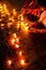 People burning oil lamps as religious ritual in Hindu temple