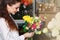 People, business, sale and floristry concept - happy smiling florist