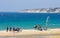 People on busy active kitesurfing beach in Spain