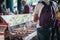 People buying cakes from a market stall in Borough Market, London, UK.