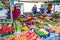 People buying fruits and vegetables at market stall in Portobello Road Market, Notting Hill, United Kingdom