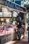 People buying meat from Northfield Butchery shop at Borough Market, London, UK.