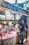 People buying meat from Northfield Butchery shop at Borough Market, London, UK.