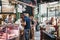 People buying meat from Northfield Butchery shop at Borough Market, London, UK.