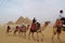 People on the camels near Great Pyramids of Giza in Egypt