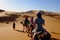 People on the camels in Sahara desert