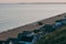 People camping and fishing on a beach by the huts in Milford on Sea, New Forest, UK