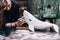 People carefully work on a ceramic whale in workshop