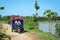 People carry flowers on rural road in An Giang, Vietnam