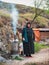 People of Caucasus. Old Dagestani avar lady. The hospitable hostess of an authentic cafe poses by the hearth where delicious