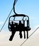 people on chairlift with skis