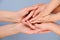 People, charity, family and care concept - close up of woman hands holding girl and boy hands