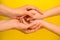 People, charity, family and care concept - close up of woman hands holding girl hands