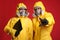 People in chemical protective suits with blood sample and clipboard on background. Virus research