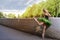 People in Choreography. Natural Portrait of Artistic Professional Caucasian Ballet Dancer in Green Tutu Dress Posing in Park